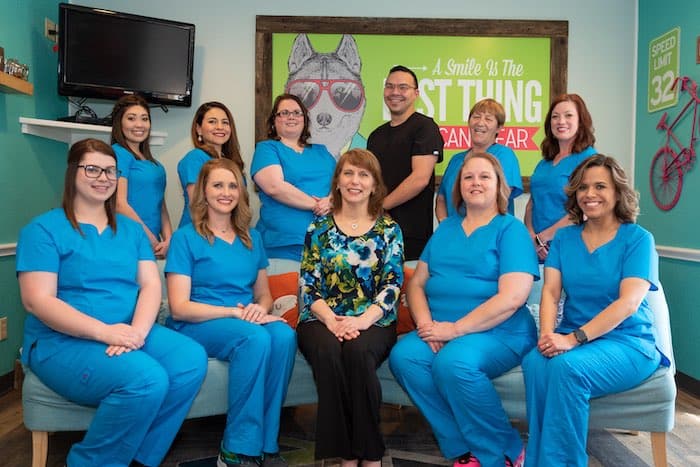 Bellmead Kids Dentistry team members sitting for a photo shoot inside the office sitting room